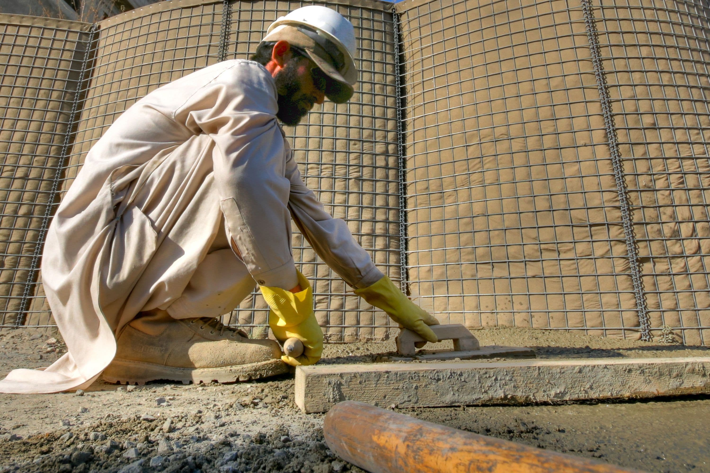 Worker spreading concrete