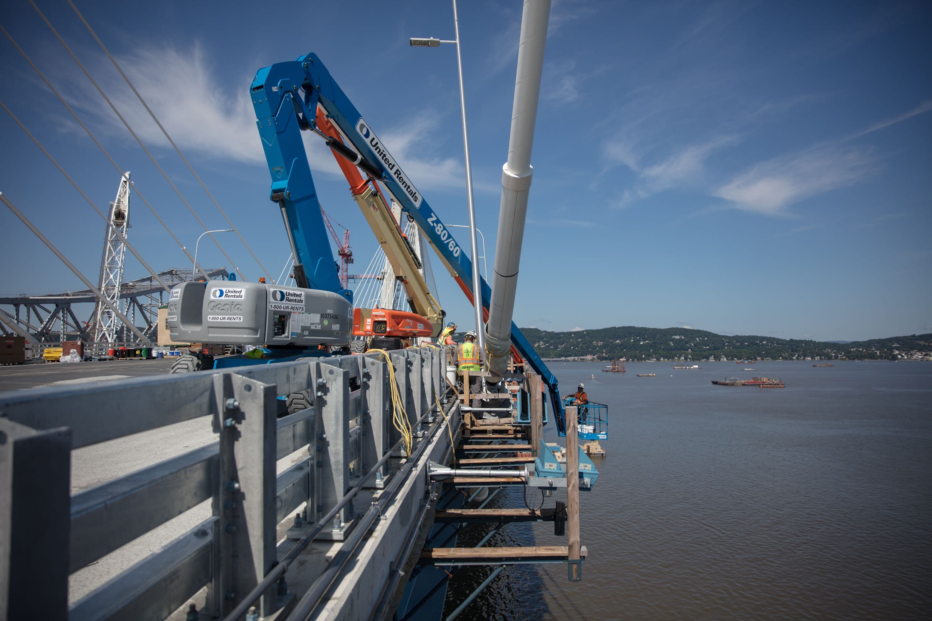 Workers inspect the main span's stay cables
