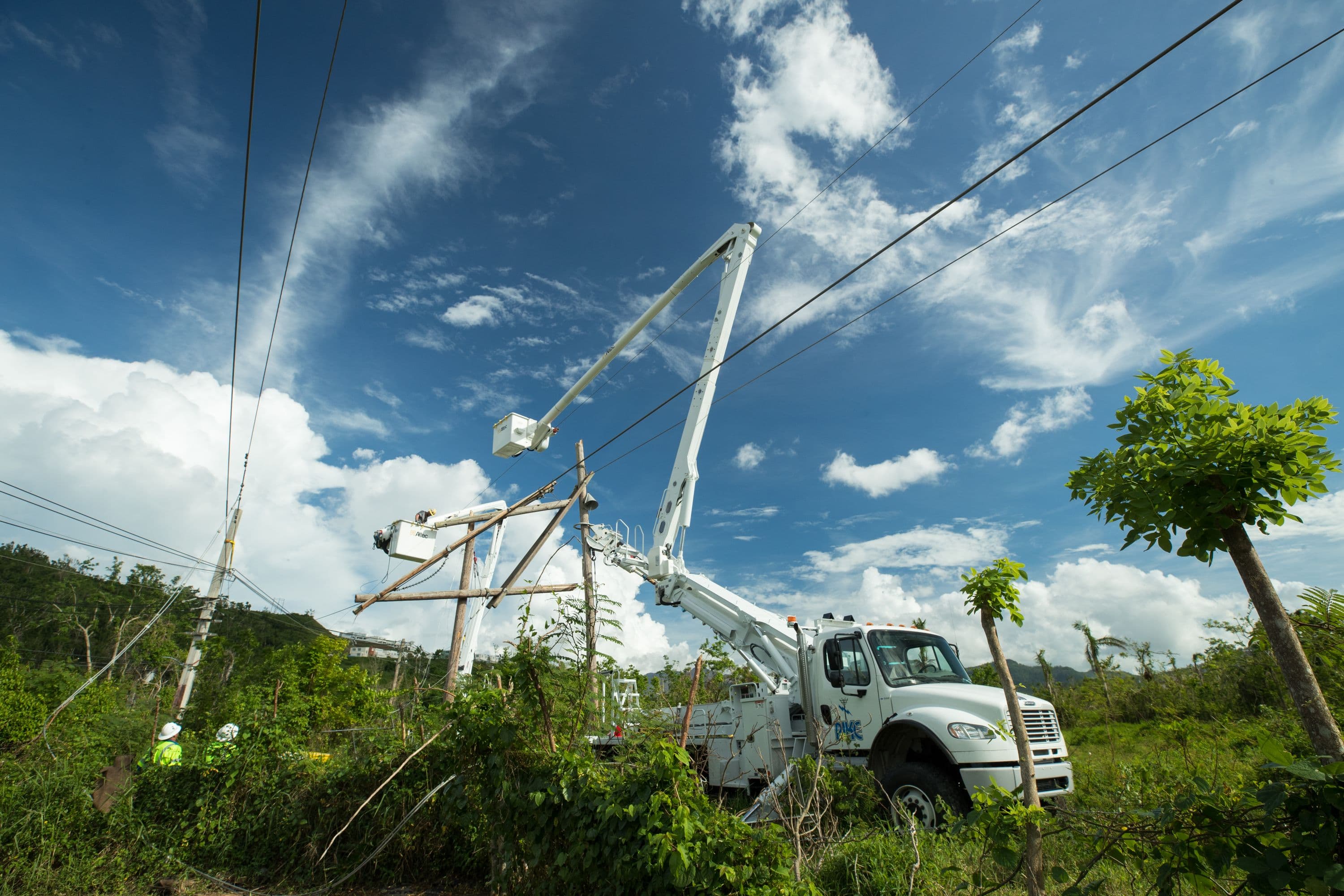 Transmission crew repairing downed power lines and poles in Puerto Rico