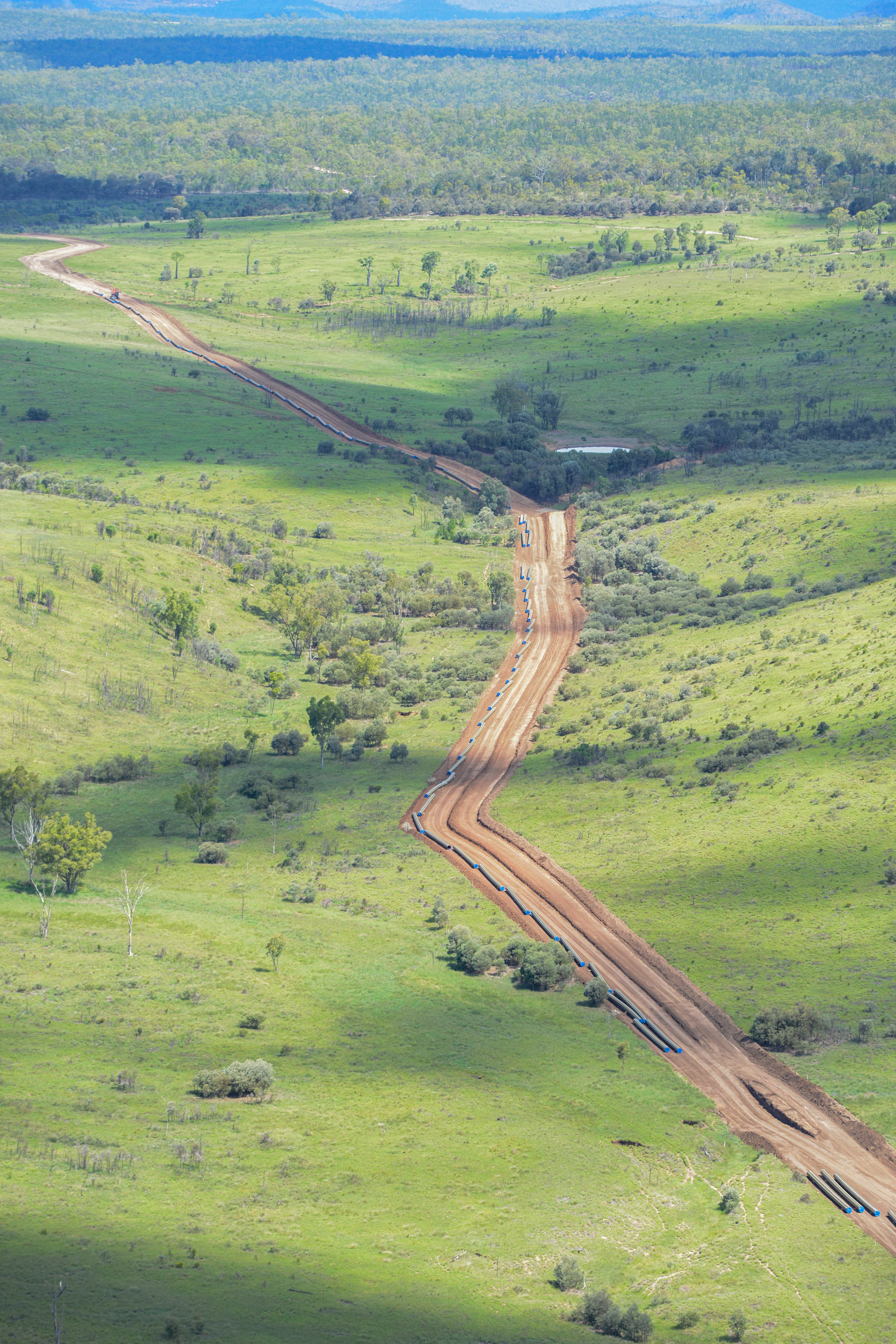 Dirt path over  green terrain